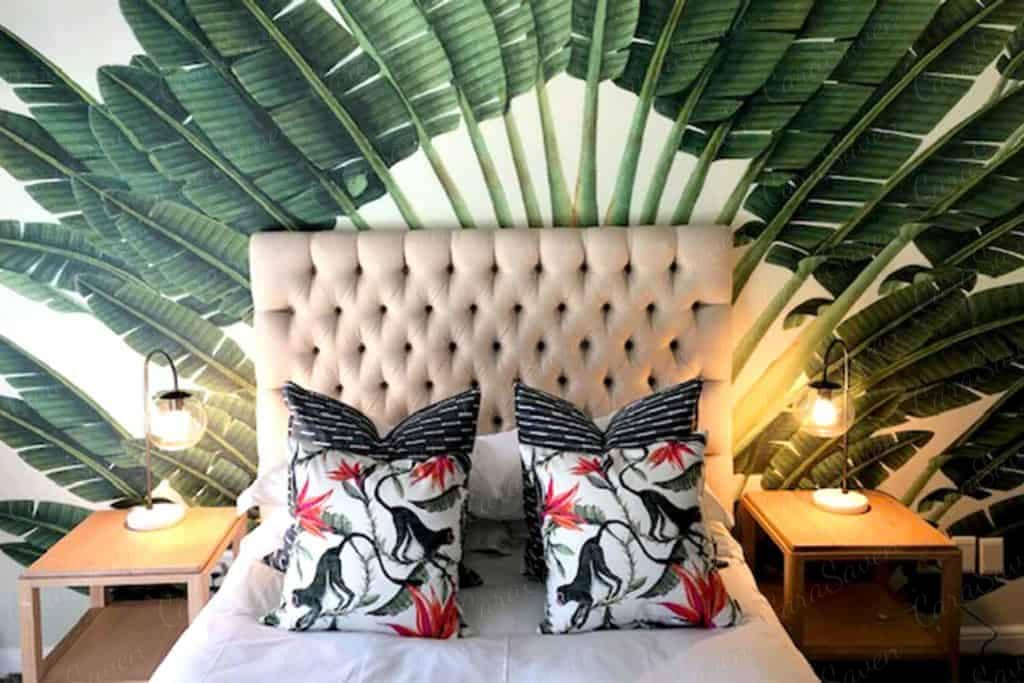 Large green palm leaves, serene backdrop, tropical design.