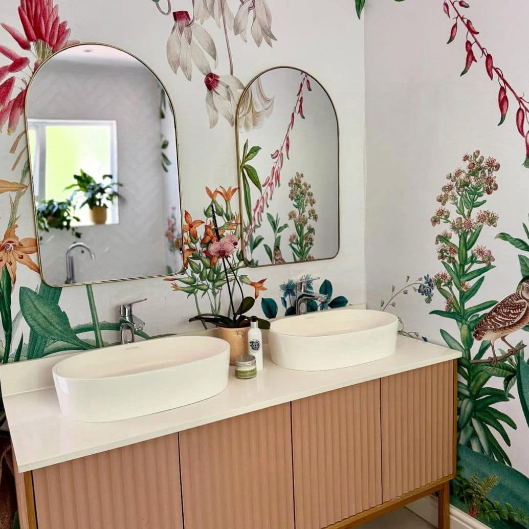 Vibrant floral and bird wallpaper featuring colorful flowers and birds in lively patterns, with bold hues of pink, green, blue, and yellow creating a dynamic focal point in the room.