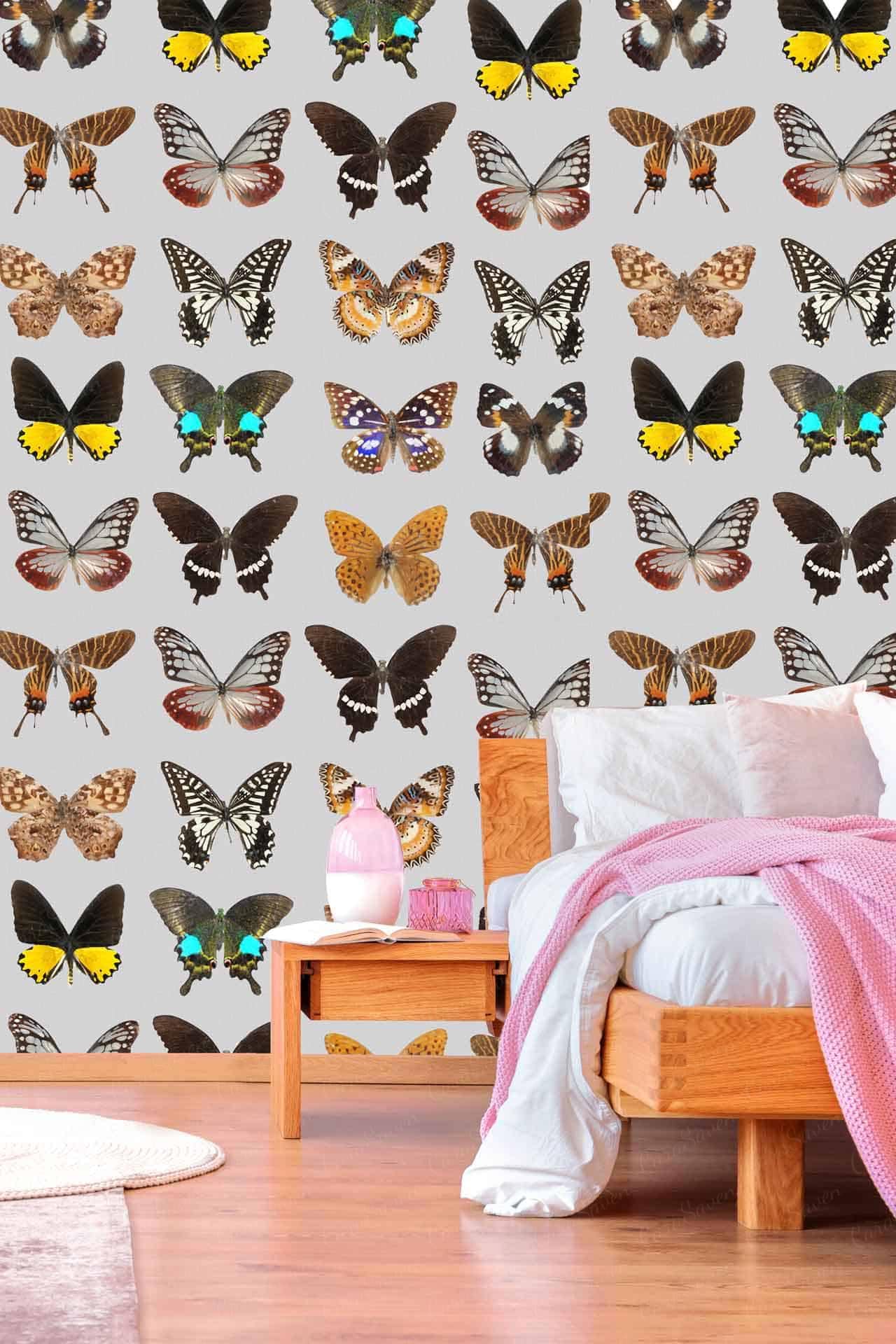 The wall is decorated with vibrant butterfly patterns in various colors and sizes. The wallpaper features butterflies in shades of blue, pink, yellow, green, and purple. These colorful designs add a charming touch to the room's decor similar to Shutterfly’s personalized products.