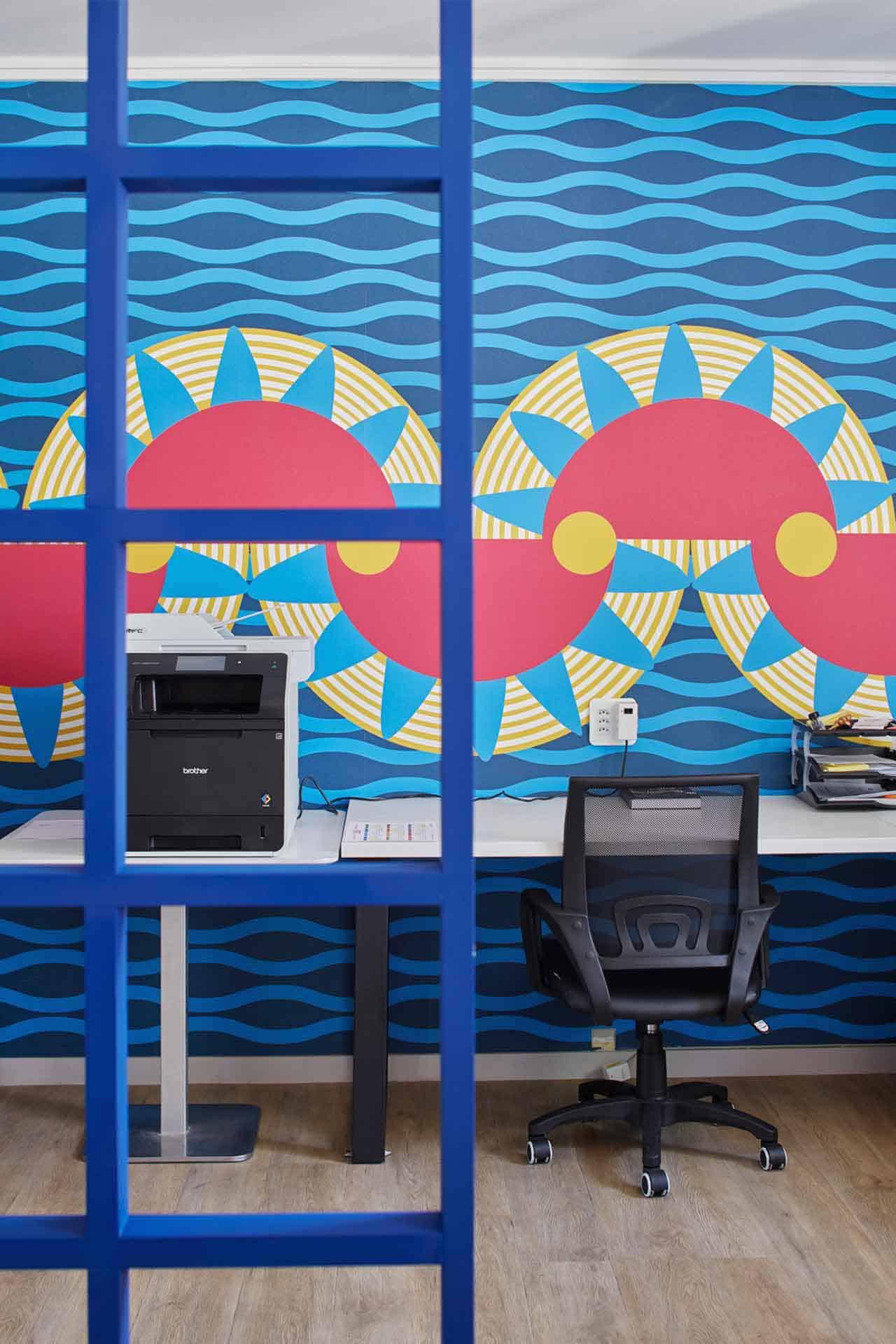 Bold, colorful wall mural. Features red, yellow, and blue geometric patterns.