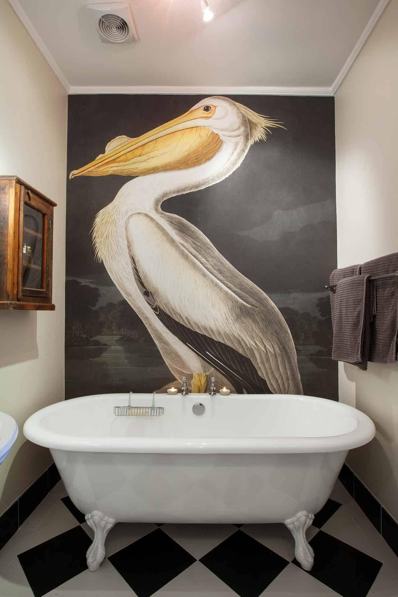 Large, detailed mural of a pelican with shades of white, gray, and yellow. Background elements include hues of blue and green to evoke a natural setting.