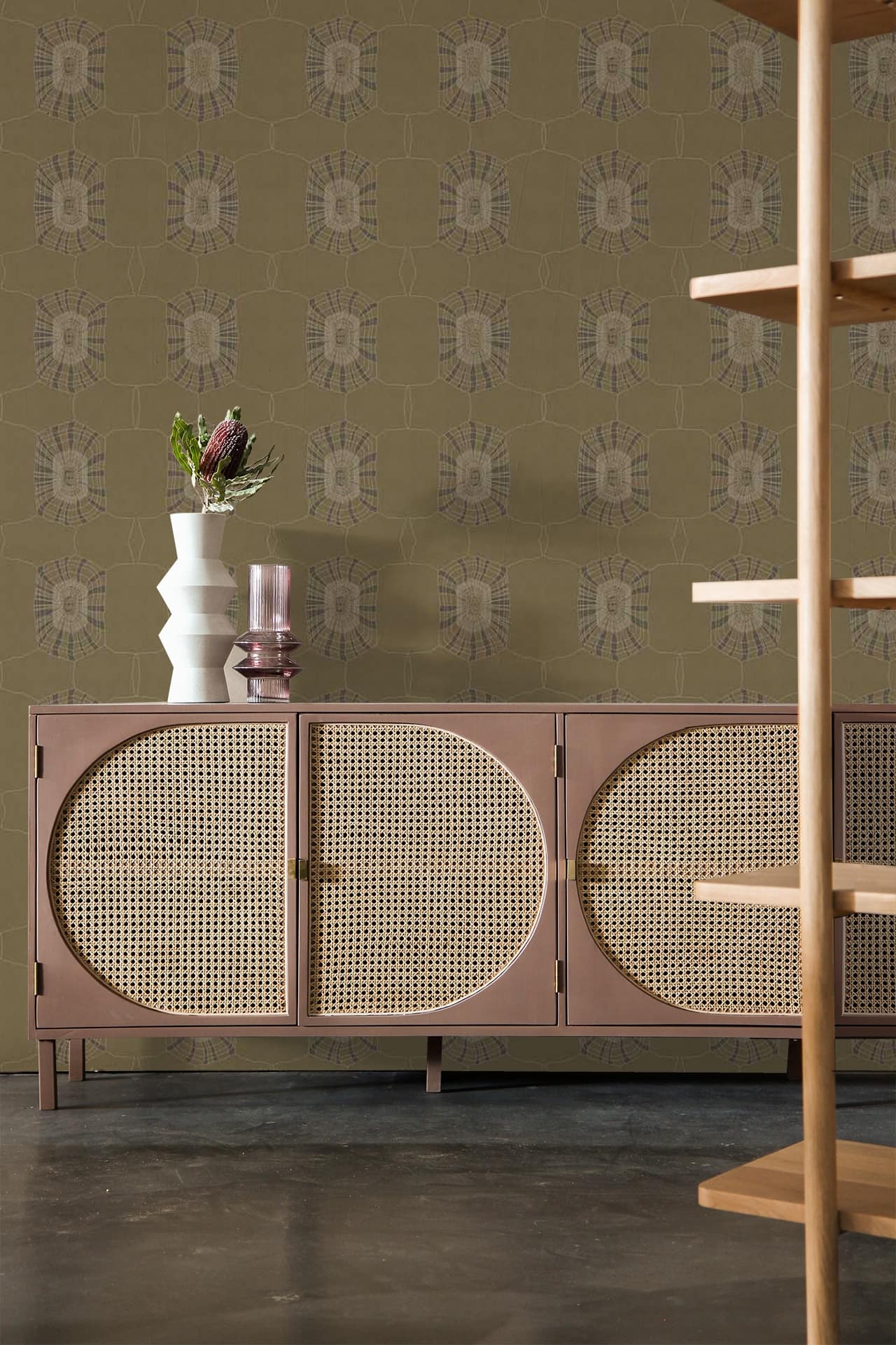 The background features an olive-green patterned wallpaper with intricate designs. The wallpaper's elements include floral motifs and geometric shapes, all in varying shades of green.