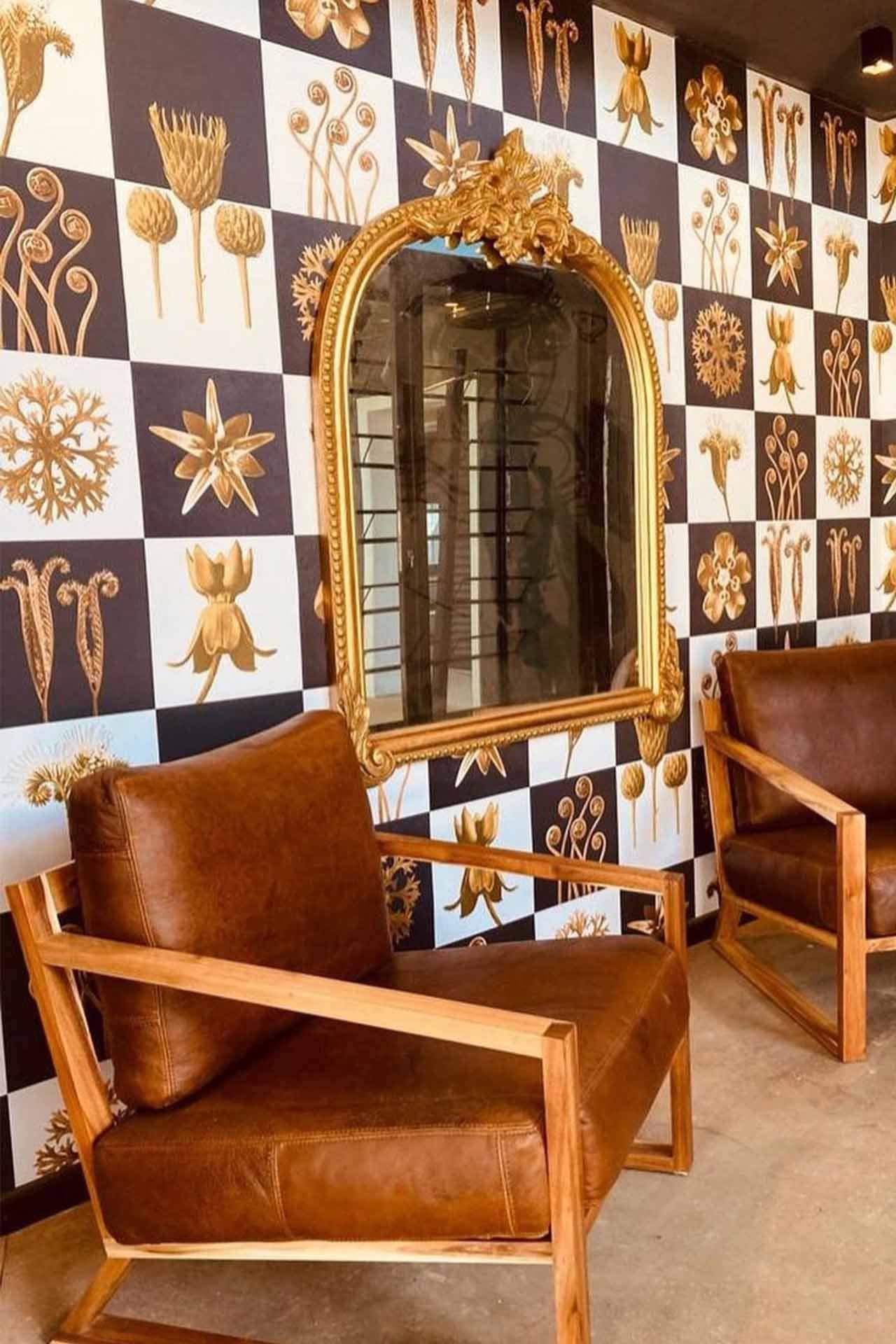 Checkered black and white wall, gold floral designs.