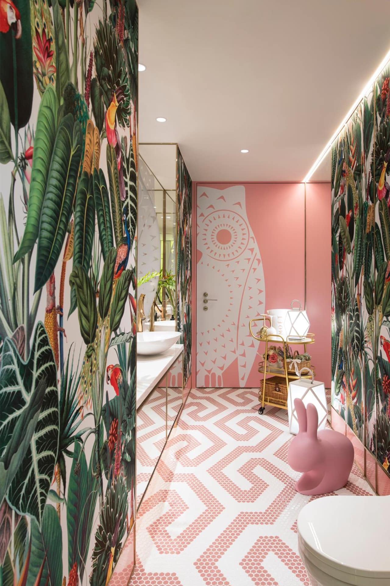 Tropical-themed wallpaper, large green leaves, colorful birds.