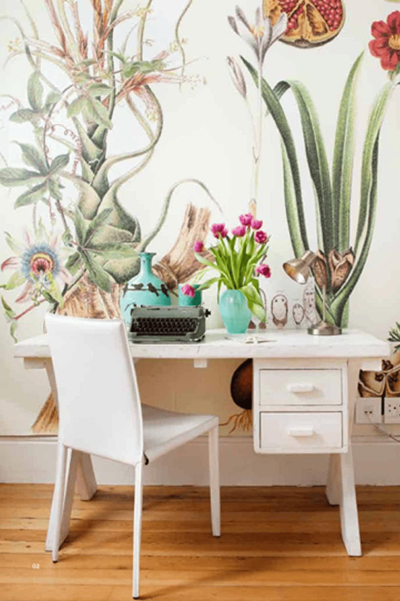 The wallpaper features botanical elements such as green leaves, pink and white flowers, and subtle hints of gold.