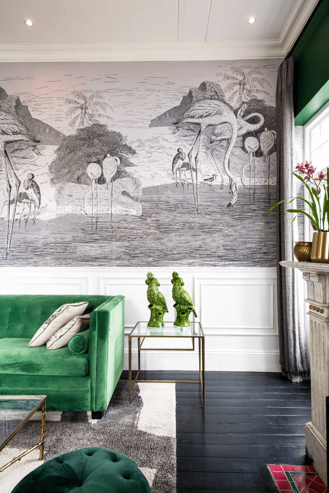 A stylish living room features a large black-and-white mural of flamingos on the wall, creating a bold focal point with its intricate bird patterns and monochromatic color scheme.