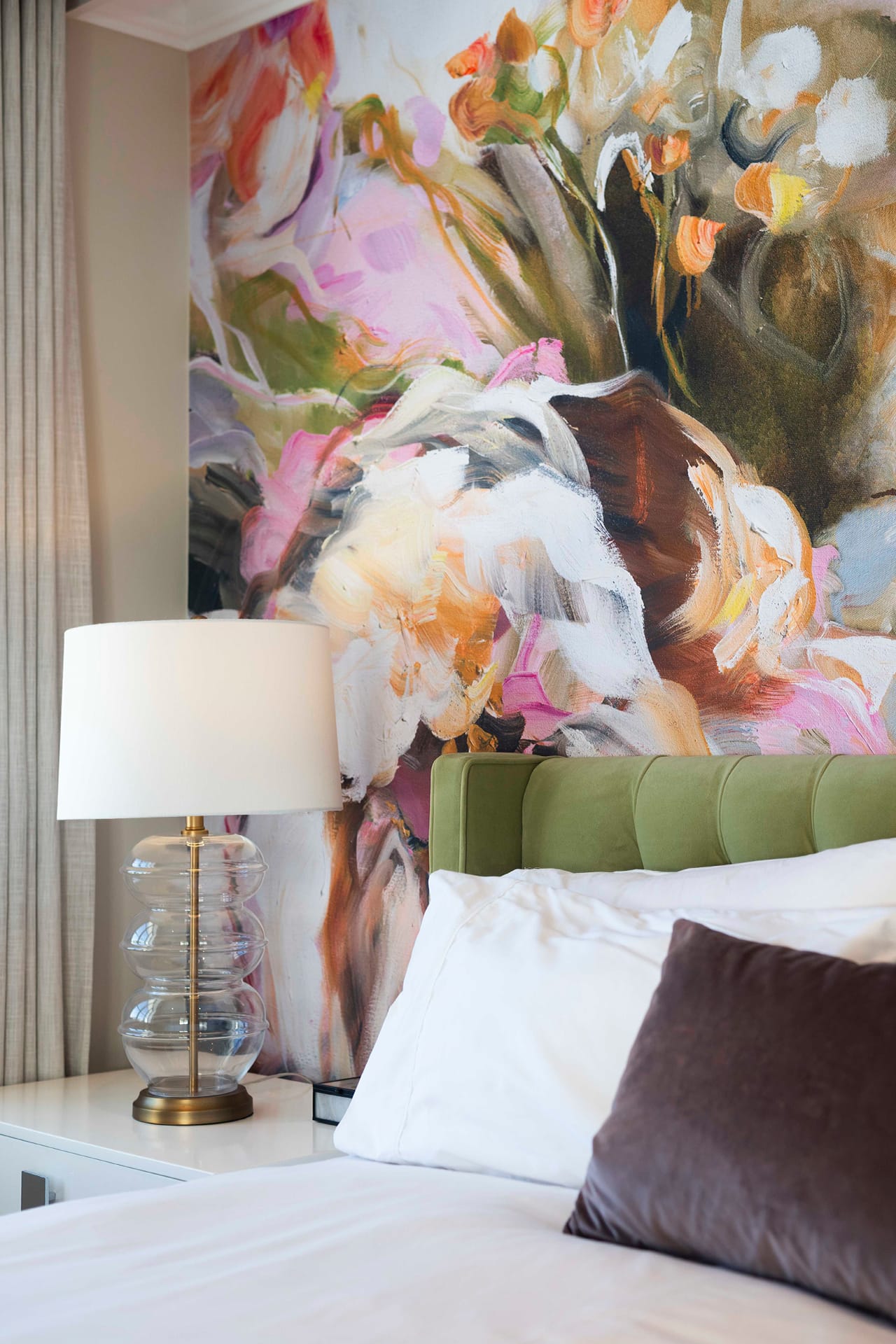 Colorful abstract floral mural wallpaper featuring bold brushstrokes in vibrant shades of teal, coral, mustard yellow, deep blue, and soft blush pink. The design includes oversized flower shapes with expressive outlines and scattered leaves, creating a modern botanical look with dynamic color contrasts and painterly texture.