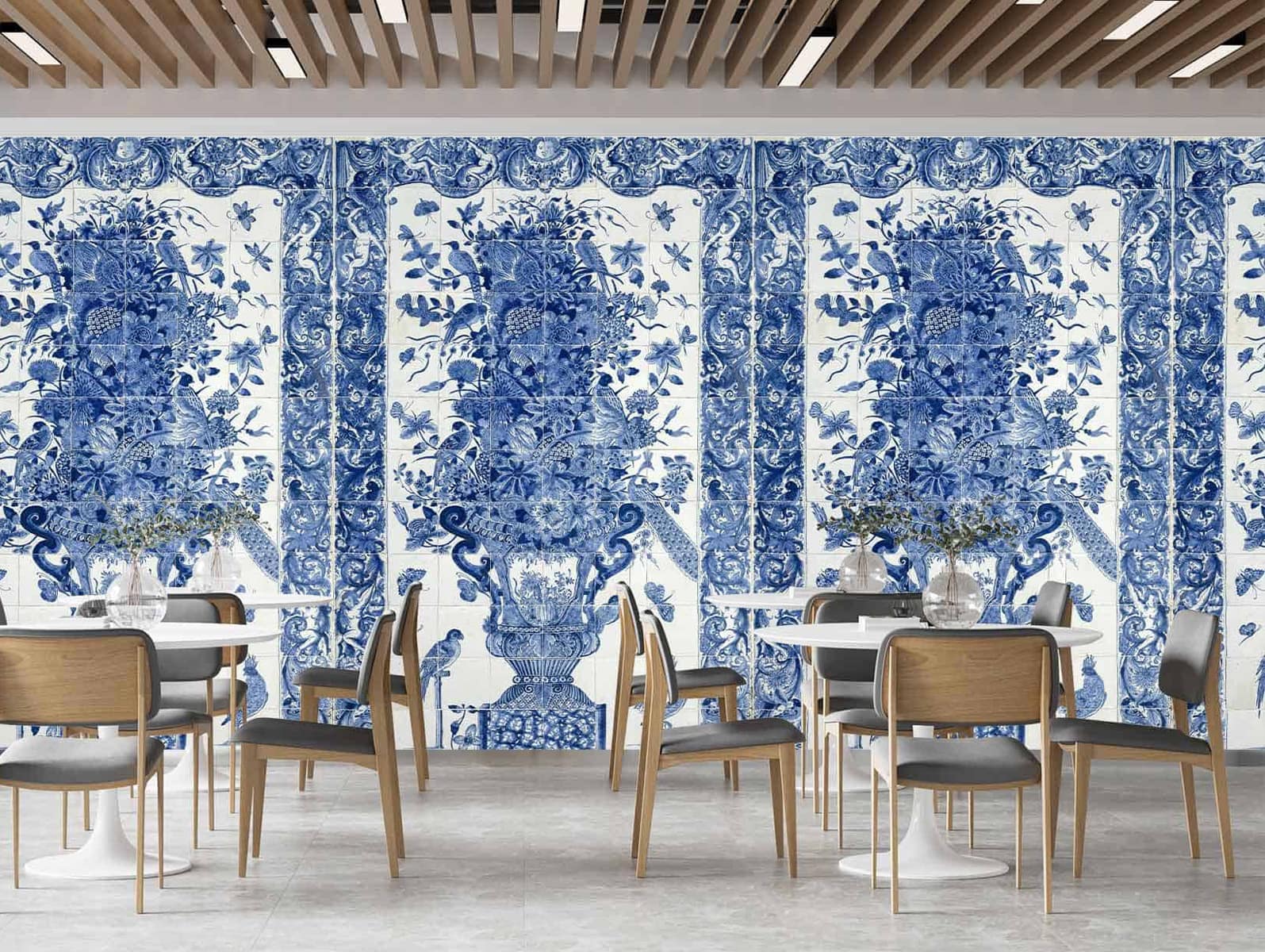 Large, intricate mural on the wall with detailed blue and white floral porcelain patterns; features elaborate flowers and swirling designs in classic cobalt blue on a white background.