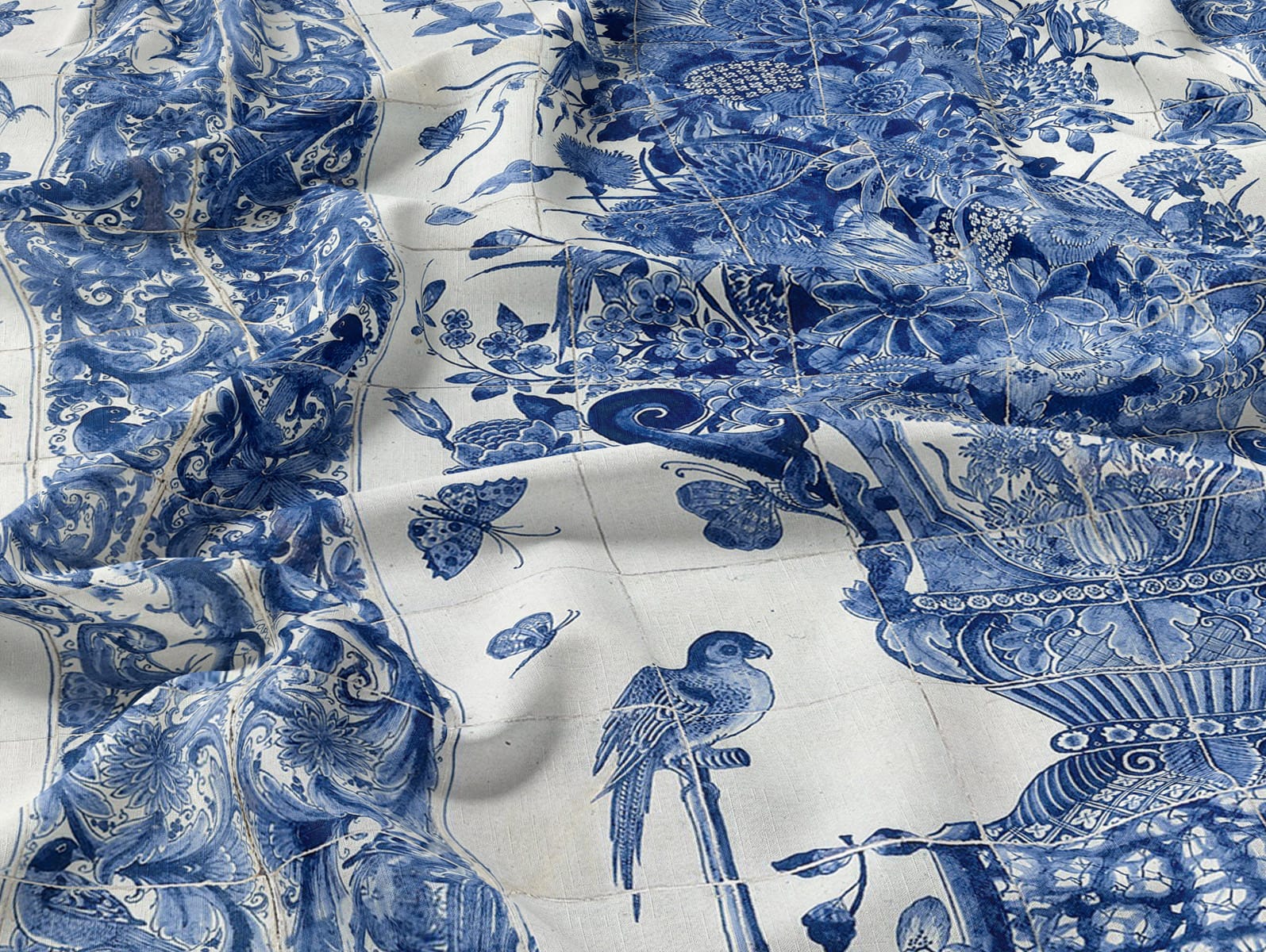 Blue and white wallpaper with intricate floral patterns, butterflies, and a bird on a branch; design resembles traditional porcelain or ceramic art.