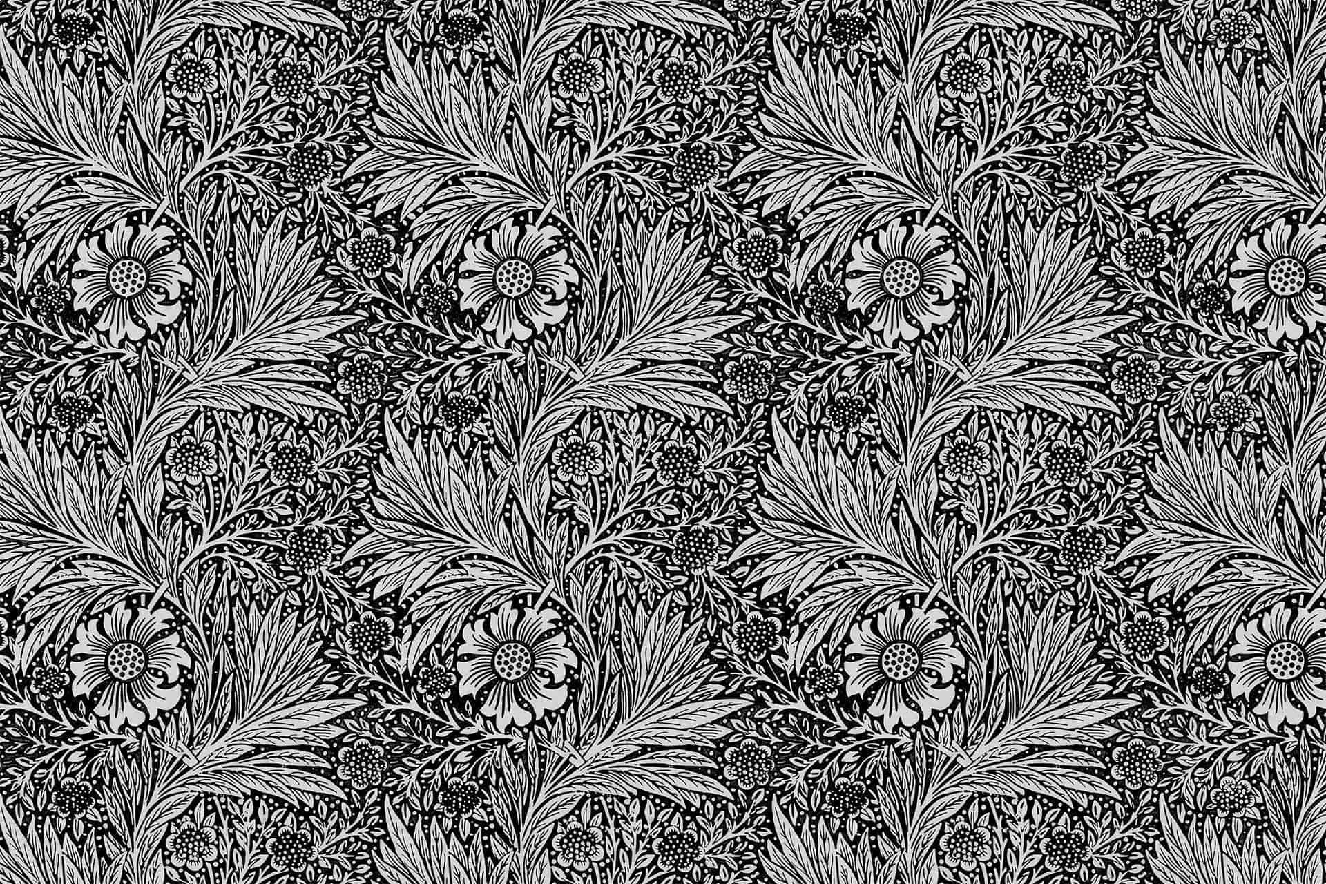 An intricate black-and-white floral pattern features large, stylized flowers with detailed petals, surrounded by smaller leaves and floral elements. This dense, repeating design evokes the essence of classic wallpaper, showcasing timeless elegance with no filter. Key elements: black-and-white palette, large detailed flowers, smaller leaves and floral motifs.