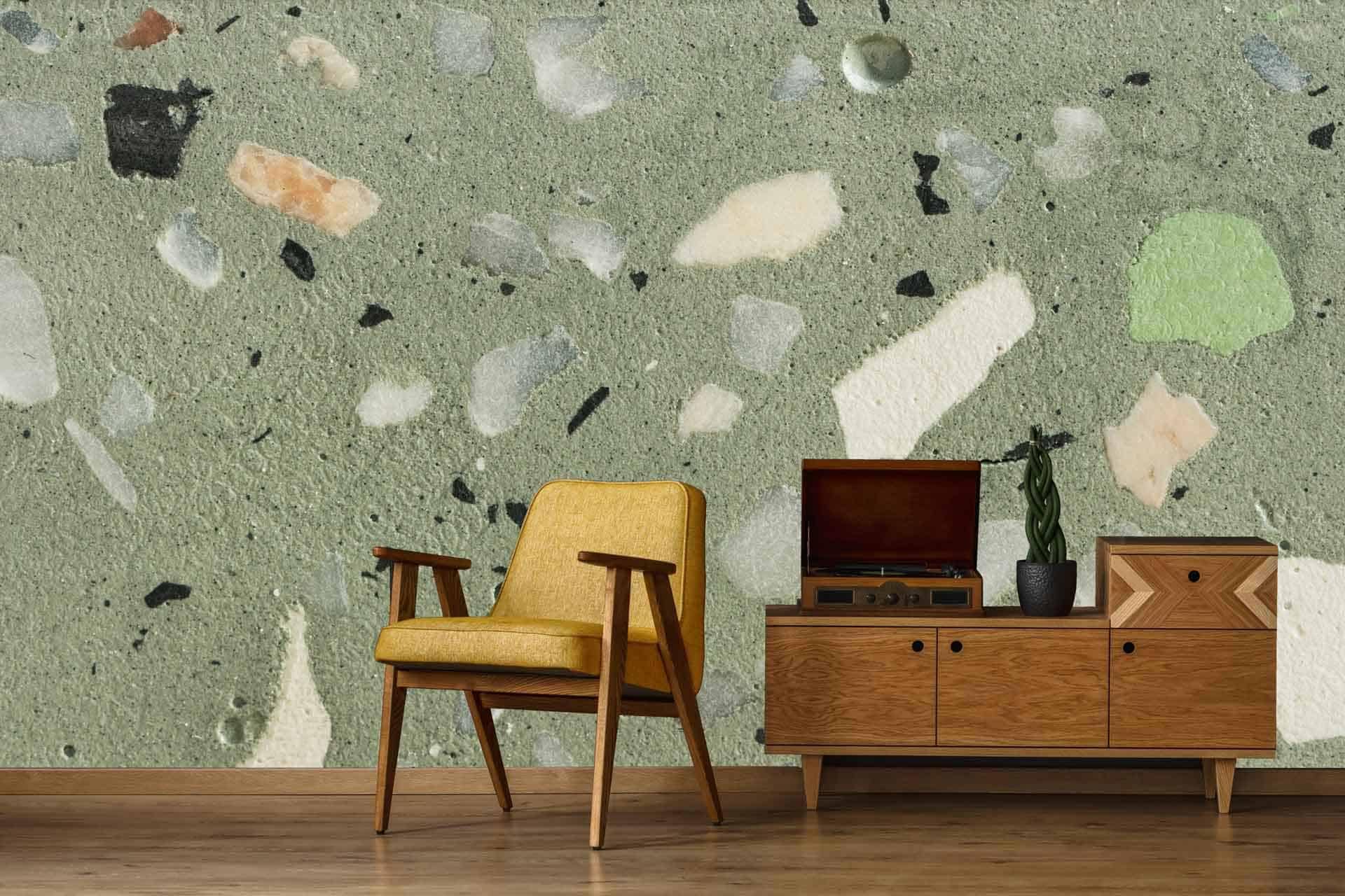 Terrazzo-patterned wallpaper with shades of green and beige. Elements include fragmented shapes in varying sizes, creating a textured and dynamic backdrop.