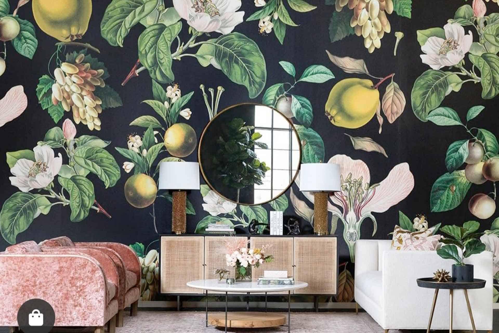 A living room featuring a striking, dark floral and fruit patterned wallpaper. The wallpaper showcases bold hues of deep green, rich burgundy, and vibrant gold in an intricate design of flowers and fruits. Ideal for a sophisticated space seeking to make a statement with its elegant botanical theme.