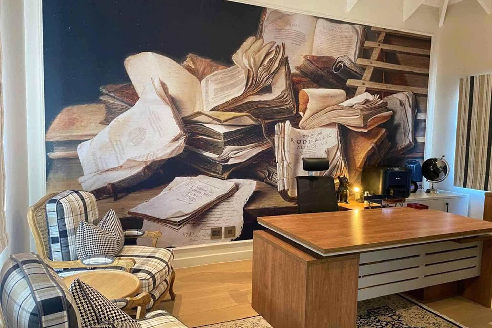 The wallpaper behind the desk features a wall mural depicting stacks of old books and papers. The color palette includes tones of sepia, brown, beige, and hints of faded parchment, perfect for an antique or vintage look.