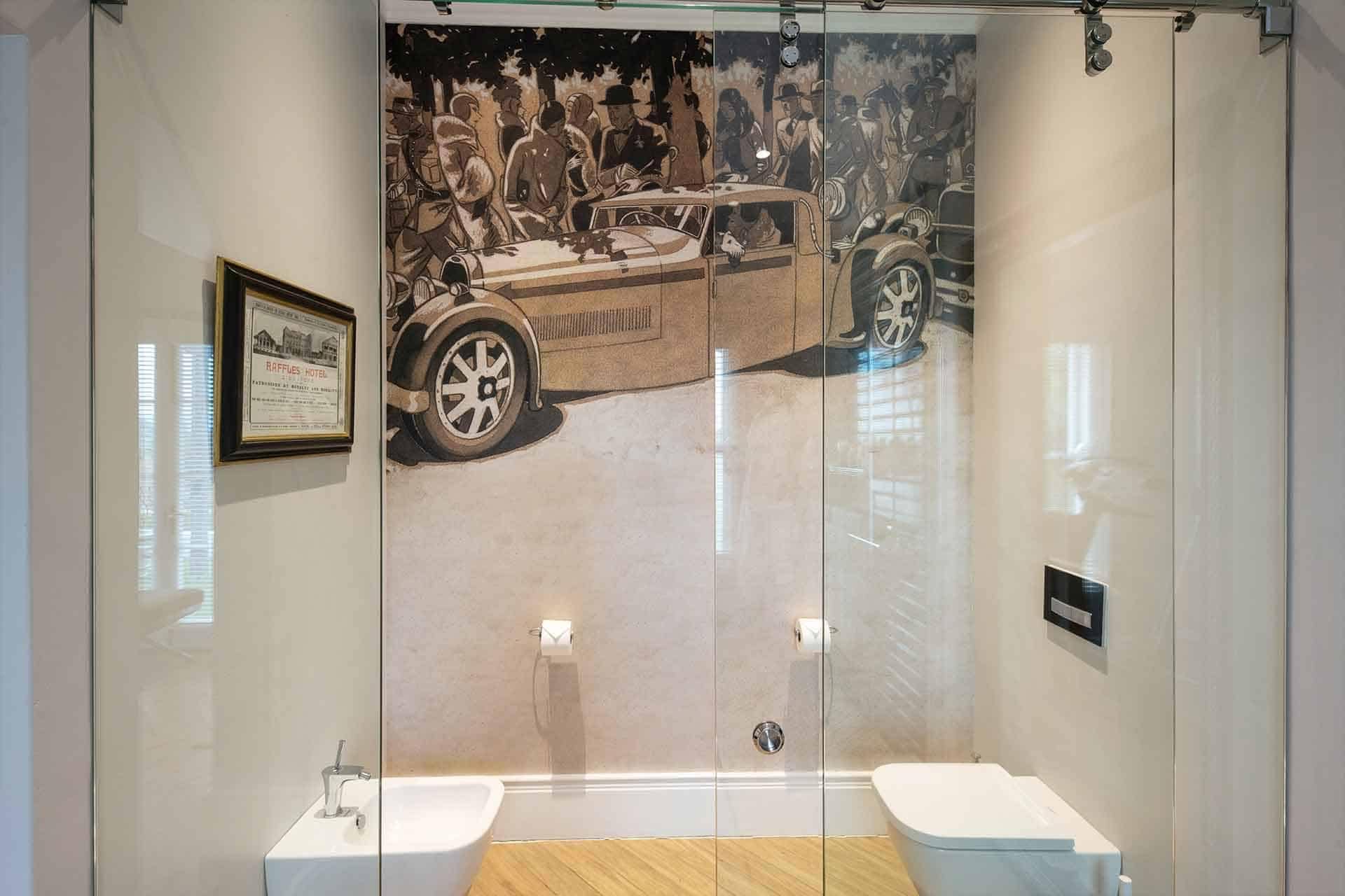 The wallpaper in the modern bathroom includes a large mural of a vintage car scene, featuring classic automobiles set against a retro urban backdrop. Rich sepia tones dominate, with splashes of muted blues and greens adding depth. Detailing includes old-fashioned streetlights, cobblestone streets, and period-dressed pedestrians. The retro cars are highlighted in polished chrome accents and deep maroon hues. This vintage-inspired mural blends seamlessly with contemporary elements for a cohesive design statement.
