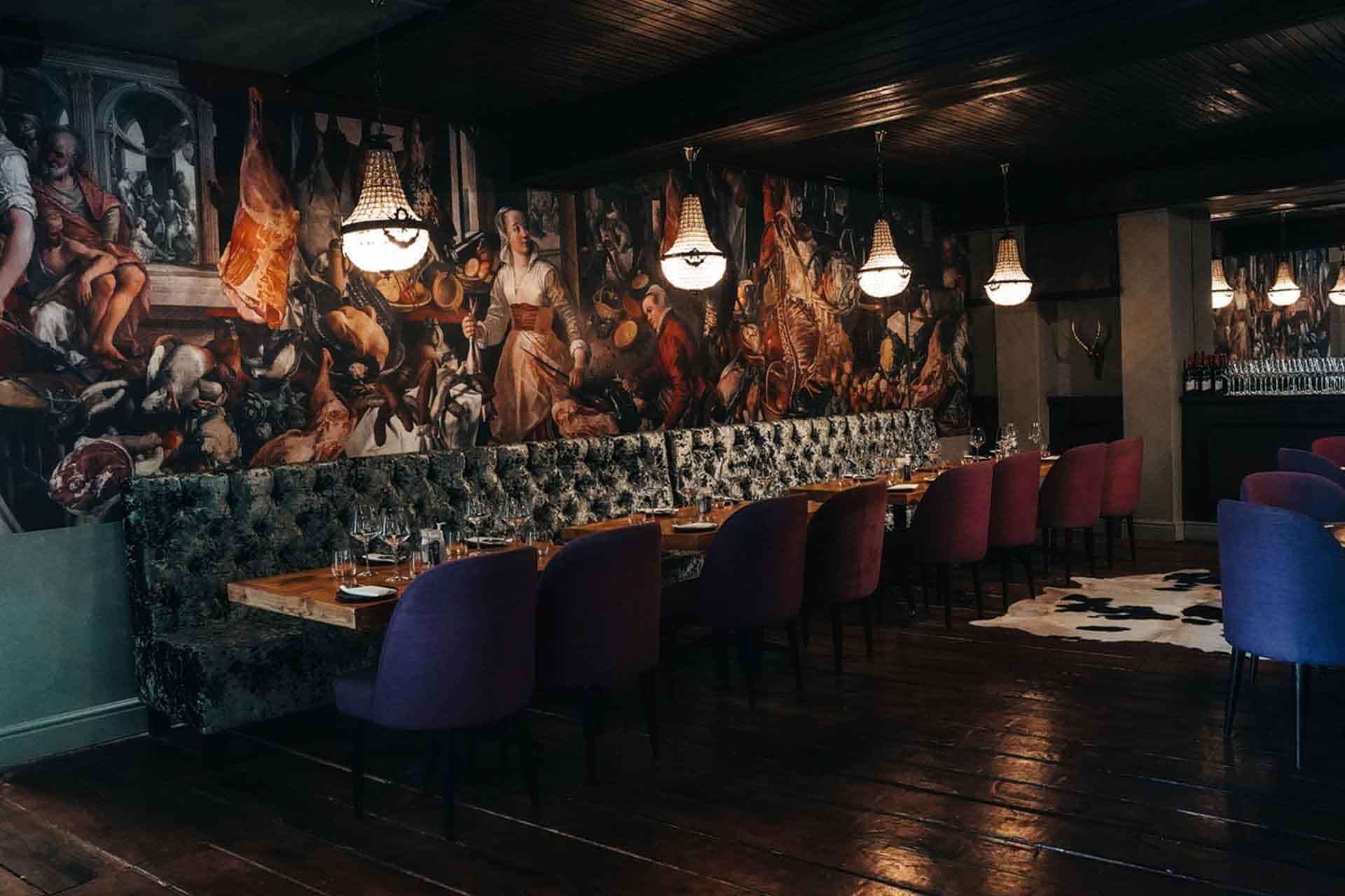 The wallpaper features large, vibrant Renaissance-style murals resembling artistic portfolio pieces. It includes rich hues such as deep reds, royal blues, and earthy greens. Intricate details showcase historical scenes and classical figures, highlighted with gold accents to add opulence.