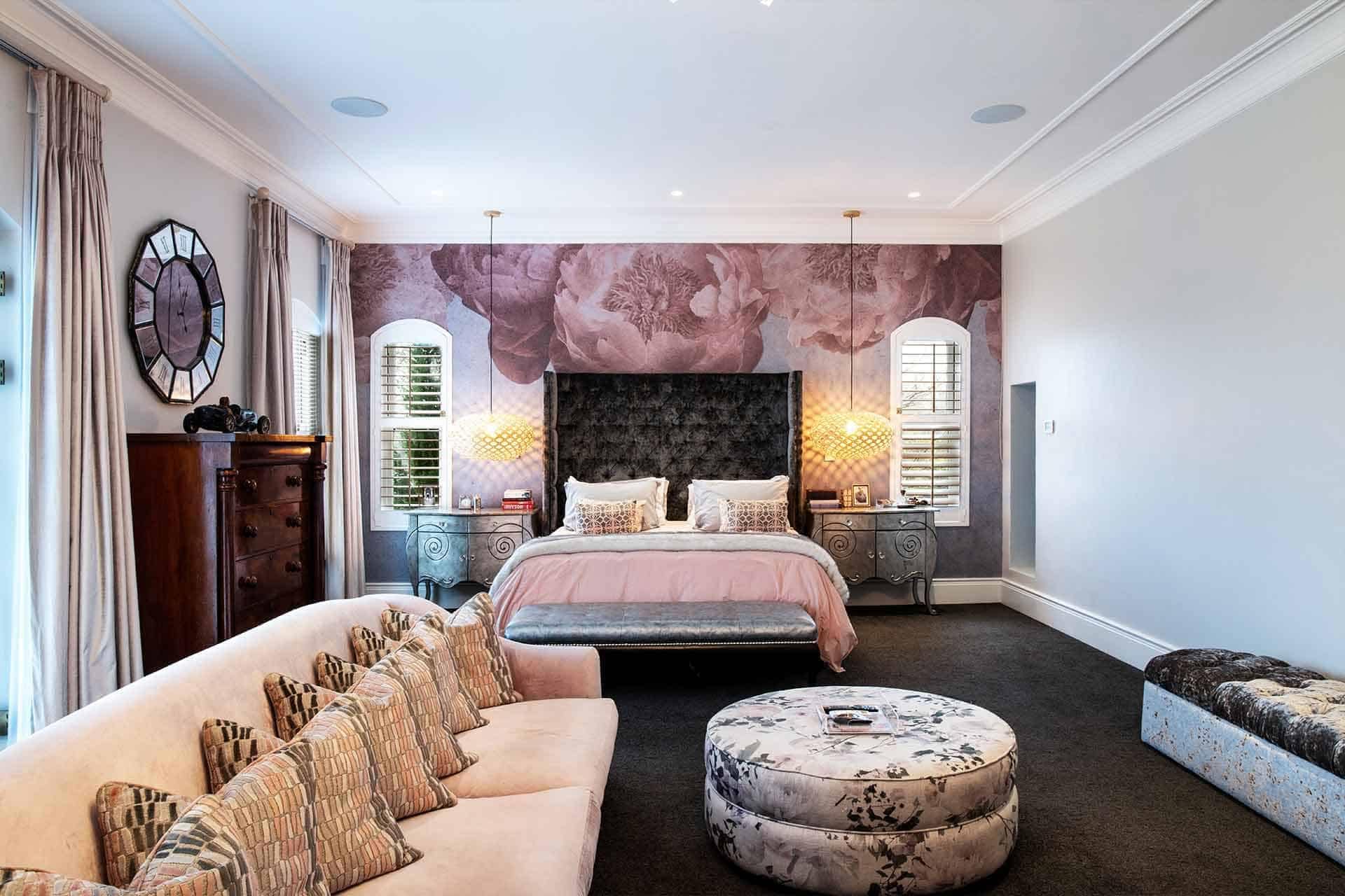 The floral accent wall showcases a stunning combination of delicate pink blossoms, lush green leaves, and intricate vine patterns set against a creamy off-white background. The soft hues of blush, rose, and pastel greens create an elegant harmony that exudes modern sophistication. Ideal for adding a touch of nature-inspired beauty to any portfolio.