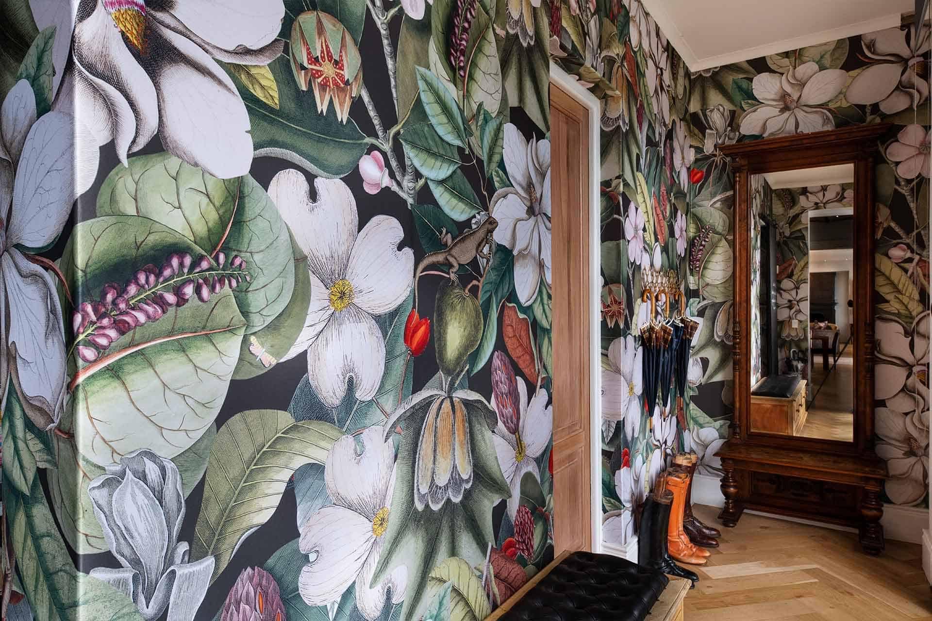 The hallway features vibrant, large-scale floral wallpaper adorned with white flowers and green leaves.