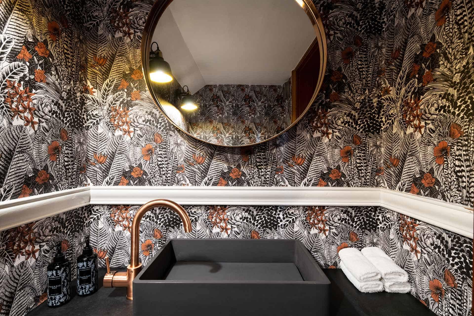 Bold, intricate floral and botanical wallpaper featuring rich hues of emerald green, deep navy, vibrant fuchsia, and warm gold accents. Highlighted with lush leaves, elaborate flower petals, delicate vines, and whimsical patterns—ideal for search terms like "floral wallpaper," "botanical print," "colorful leafy design," or "luxury nature wallpaper.