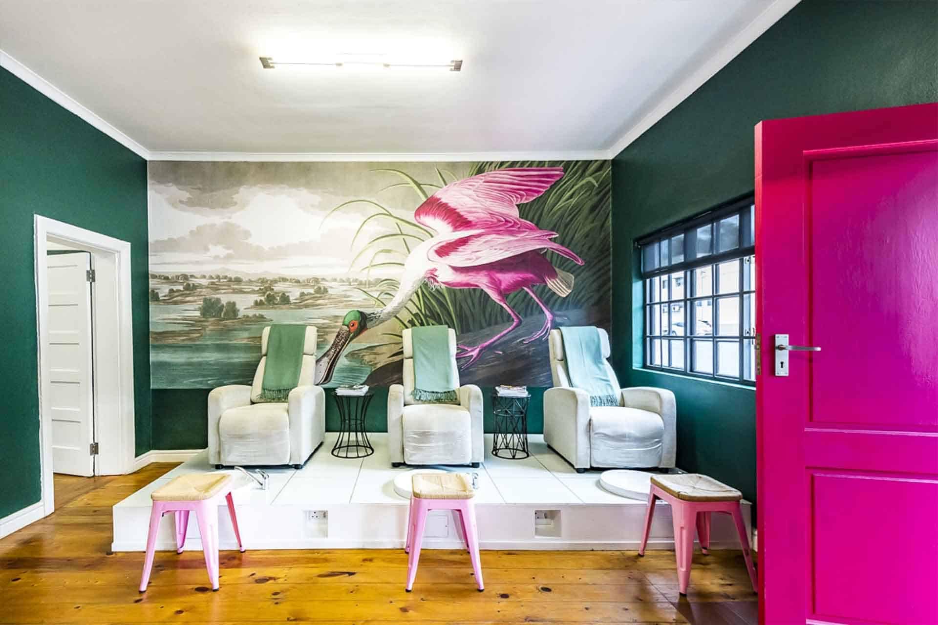 Large pink bird near a body of water.