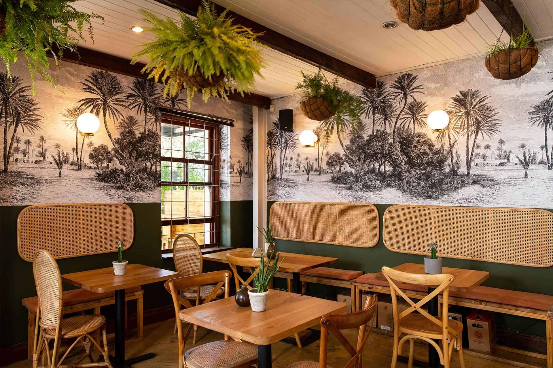 The wallpaper features a black and white mural of a tropical palm tree scene. Key elements include detailed palm trees, lush foliage, and possibly distant shoreline imagery. Colors are strictly monochrome with varying shades of black, white, and gray to create depth and contrast.