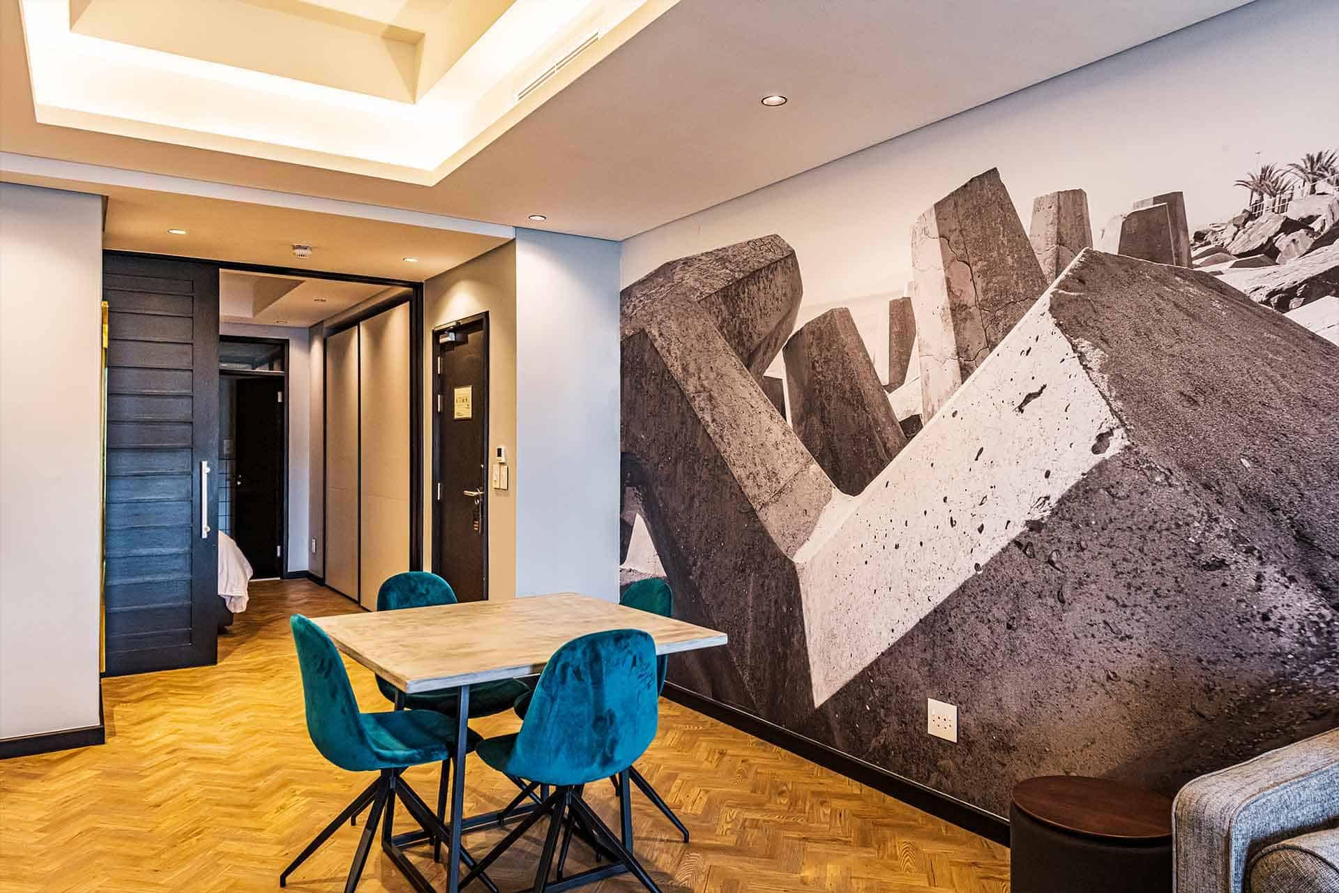 Large black and white wall mural featuring abstract stone sculptures.