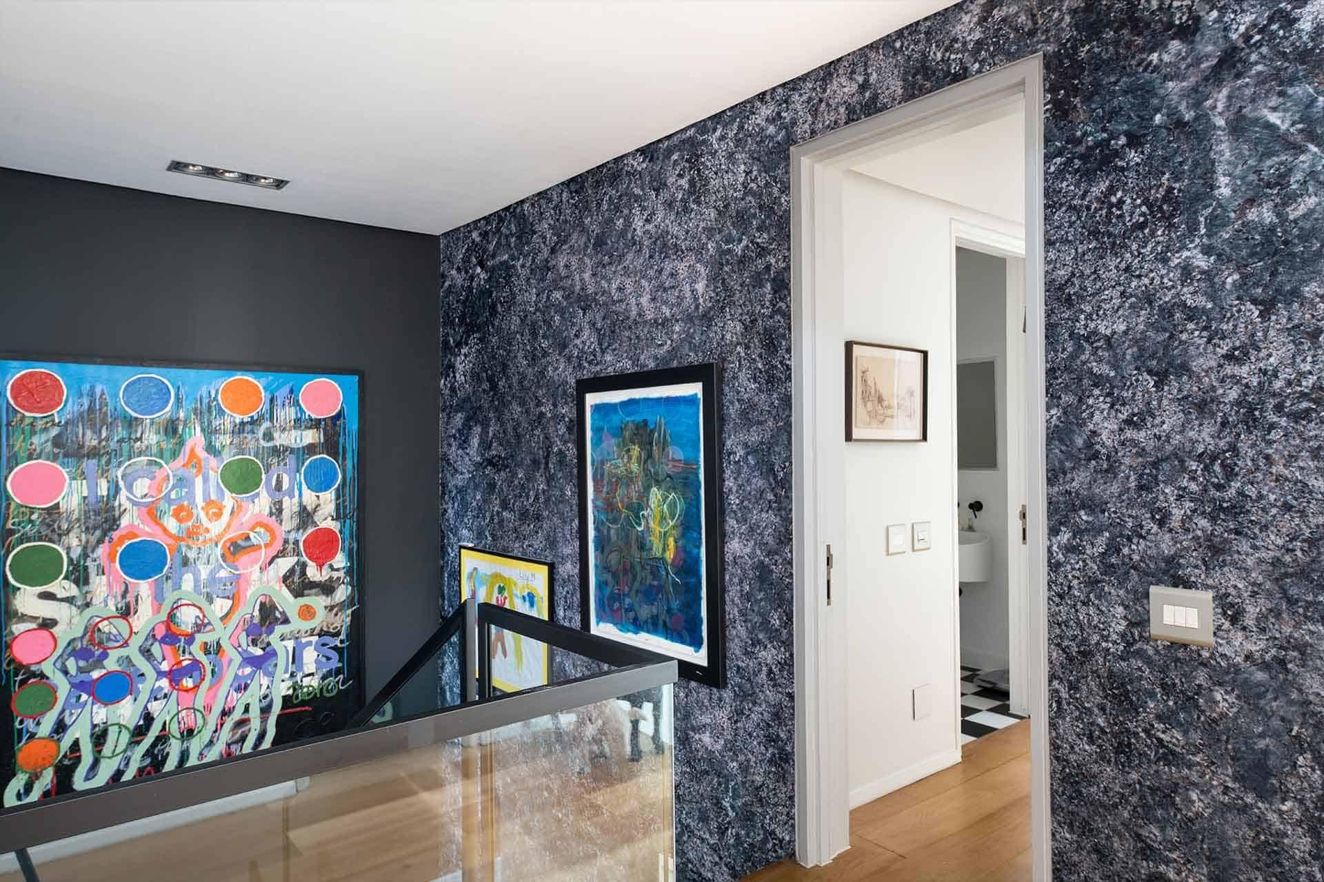 The wallpaper features abstract patterns with stone-like textures, incorporating a palette of neutral tones such as grays, beiges, and subtle hints of earthy hues.