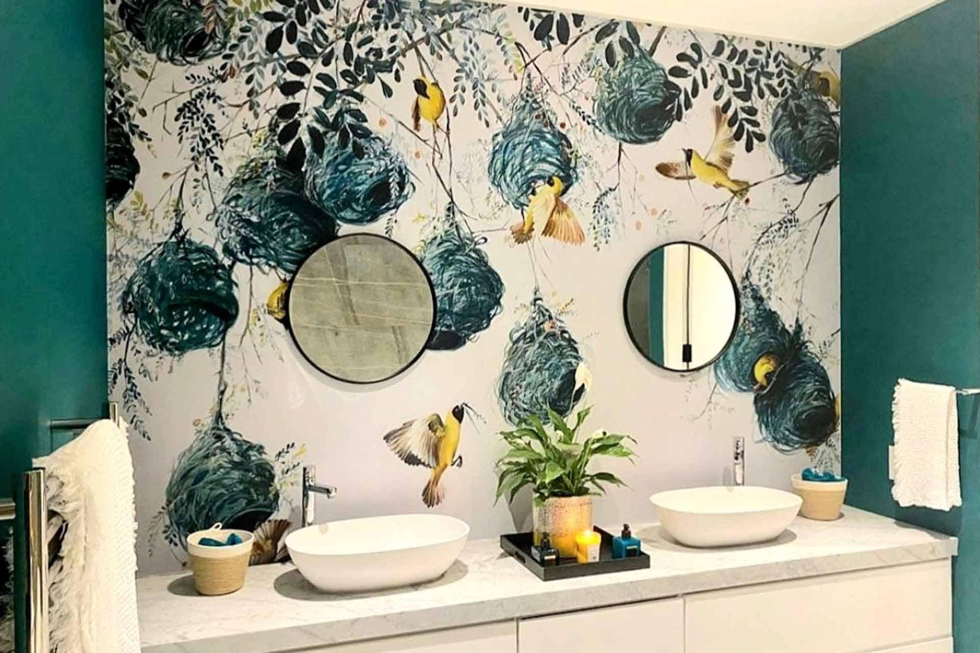 A colorful mural wallpaper features birds and nests amidst branches, adding artistic flair. The birds exhibit vibrant hues while the nests are intricately detailed among verdant branches. This design brings elements of nature indoors with a vivid color palette showcasing various shades.
