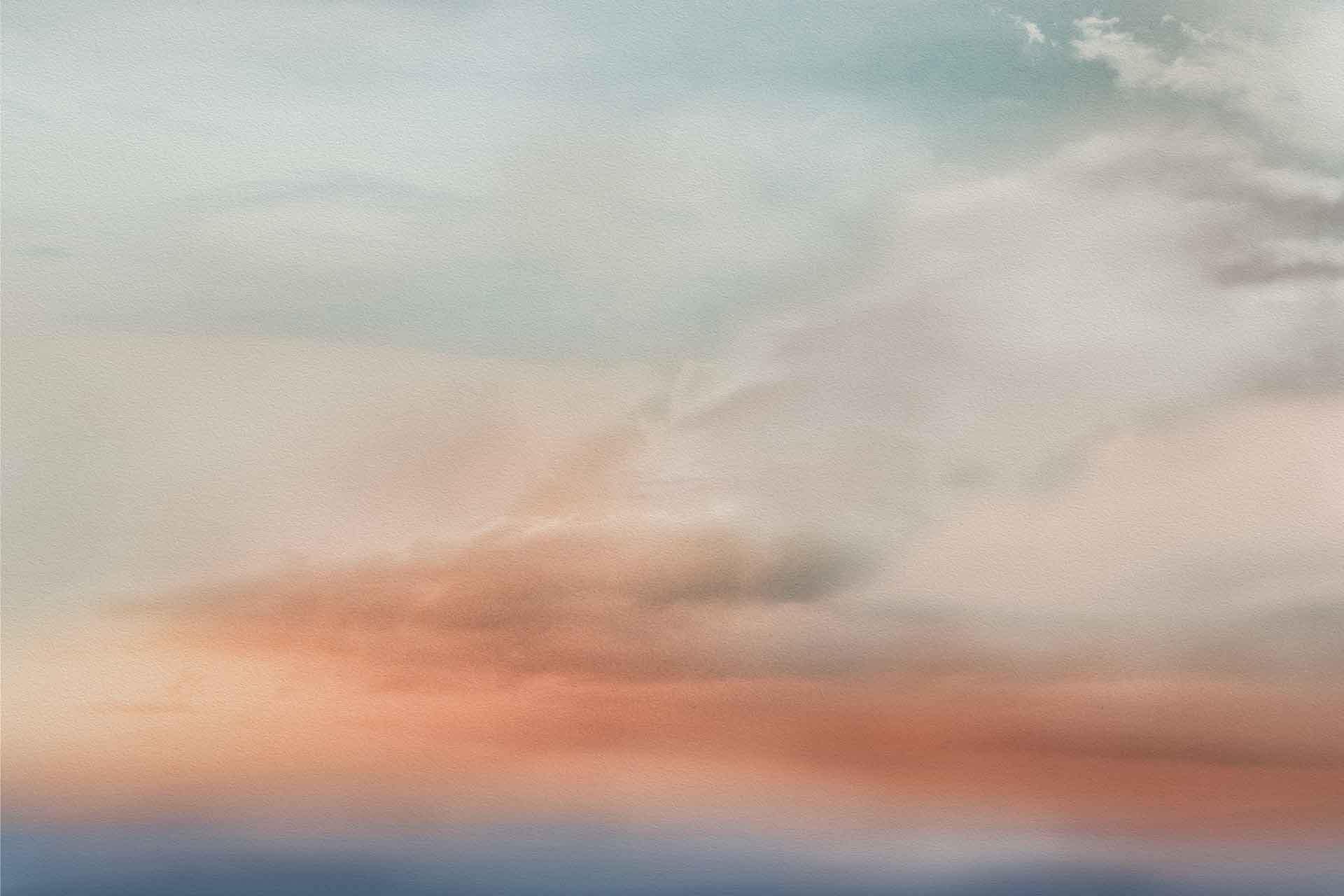 A dreamy, abstract sky wallpaper featuring soft, pastel-colored clouds in hues of orange, pink, blue, and cream. The colors blend seamlessly to create a serene and ethereal atmosphere reminiscent of a tranquil sunset or sunrise. Ideal for creating a picturesque setting with soothing tones.
