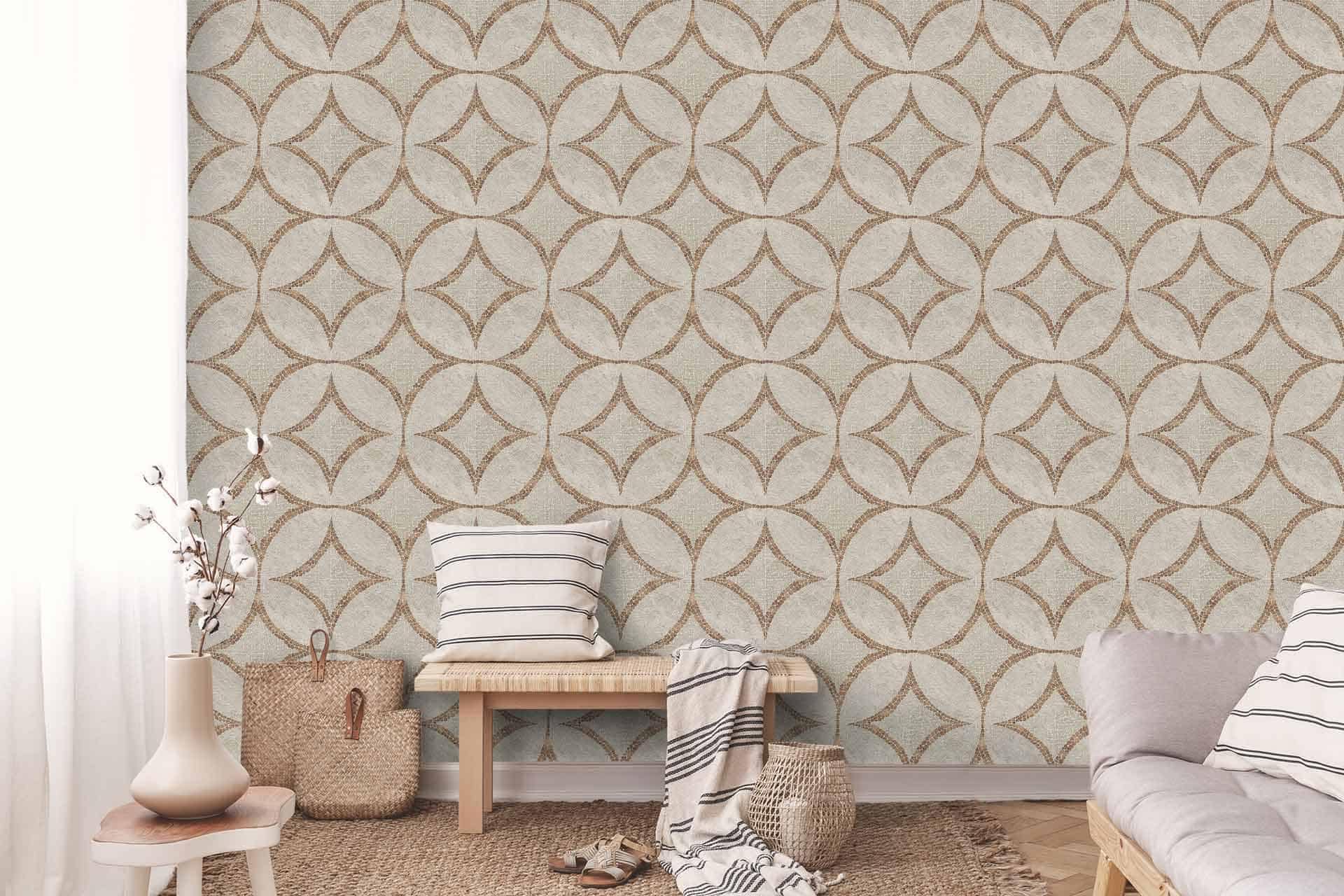 A cozy living area with a patterned feature wall displaying a geometric design in beige and light brown. The wallpaper features intricate shapes in warm, earthy tones, combining soft beige and various shades of light brown to create a harmonious and inviting atmosphere.