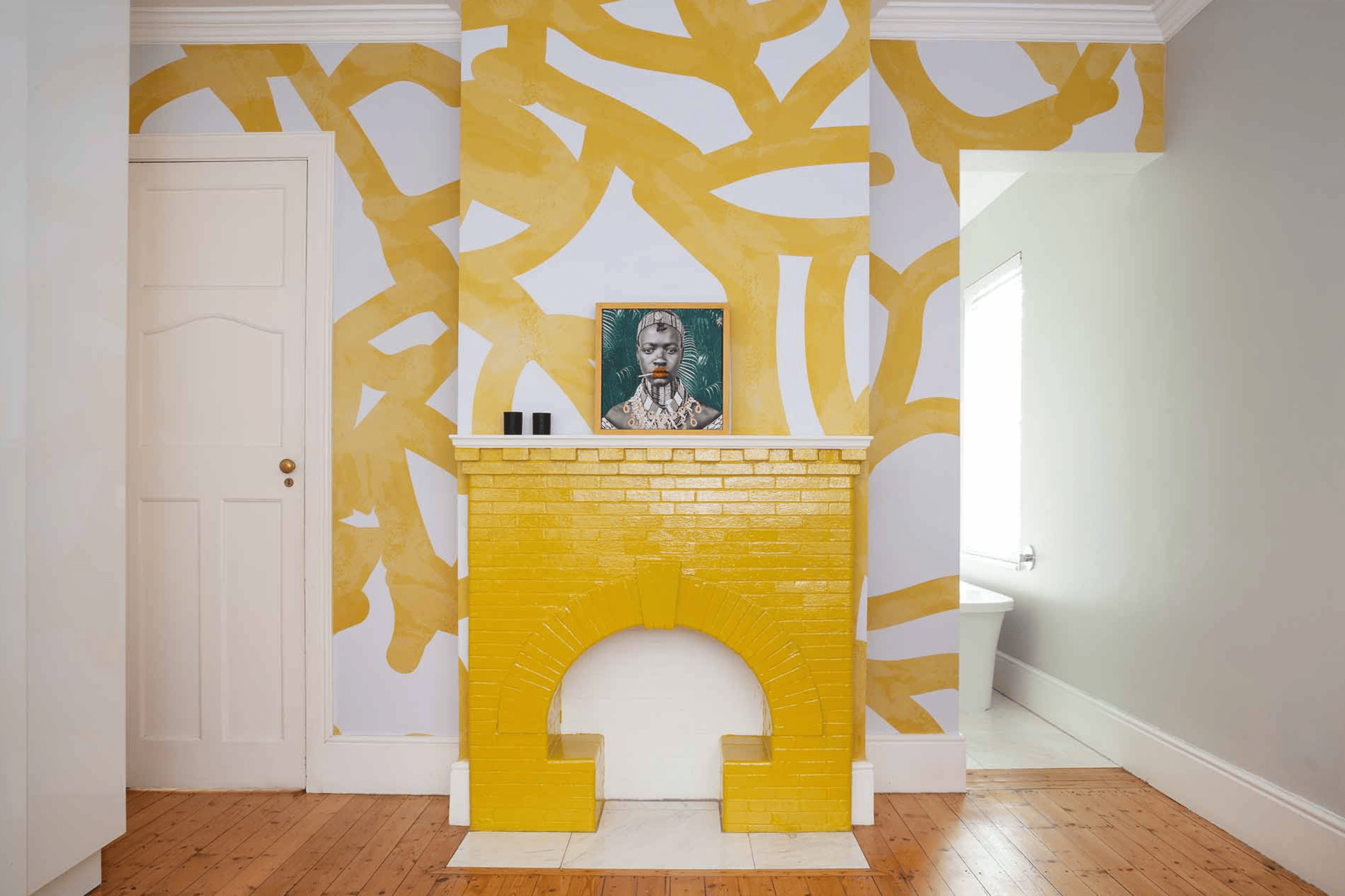 The wallpaper in the room is bold and yellow, featuring abstract patterns on a white background.