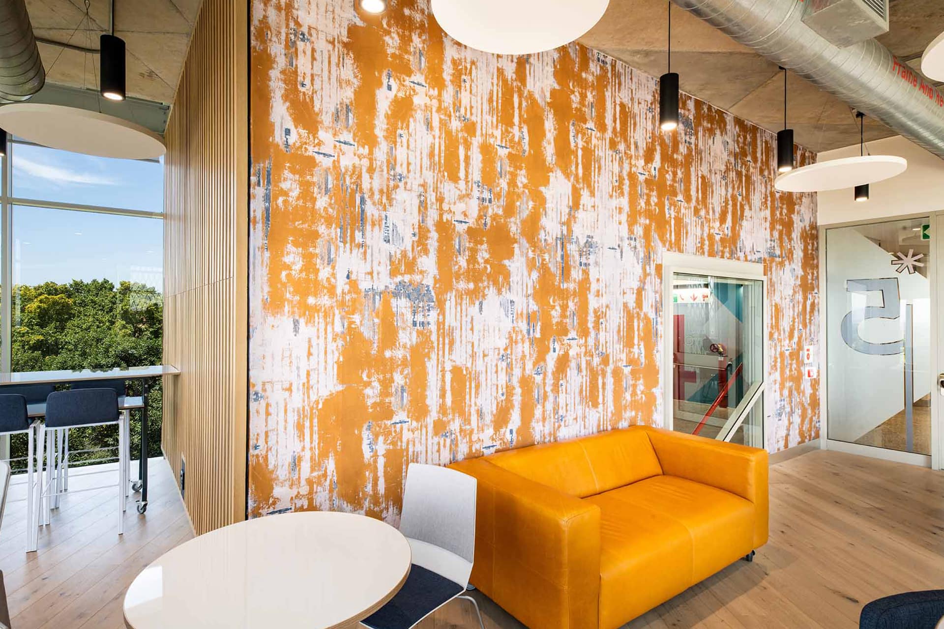 The stylish office wallpaper features an intricate blend of geometric patterns in soft greys and whites, accented by subtle metallic gold details. This contemporary design adds texture and sophistication to the modern office space.