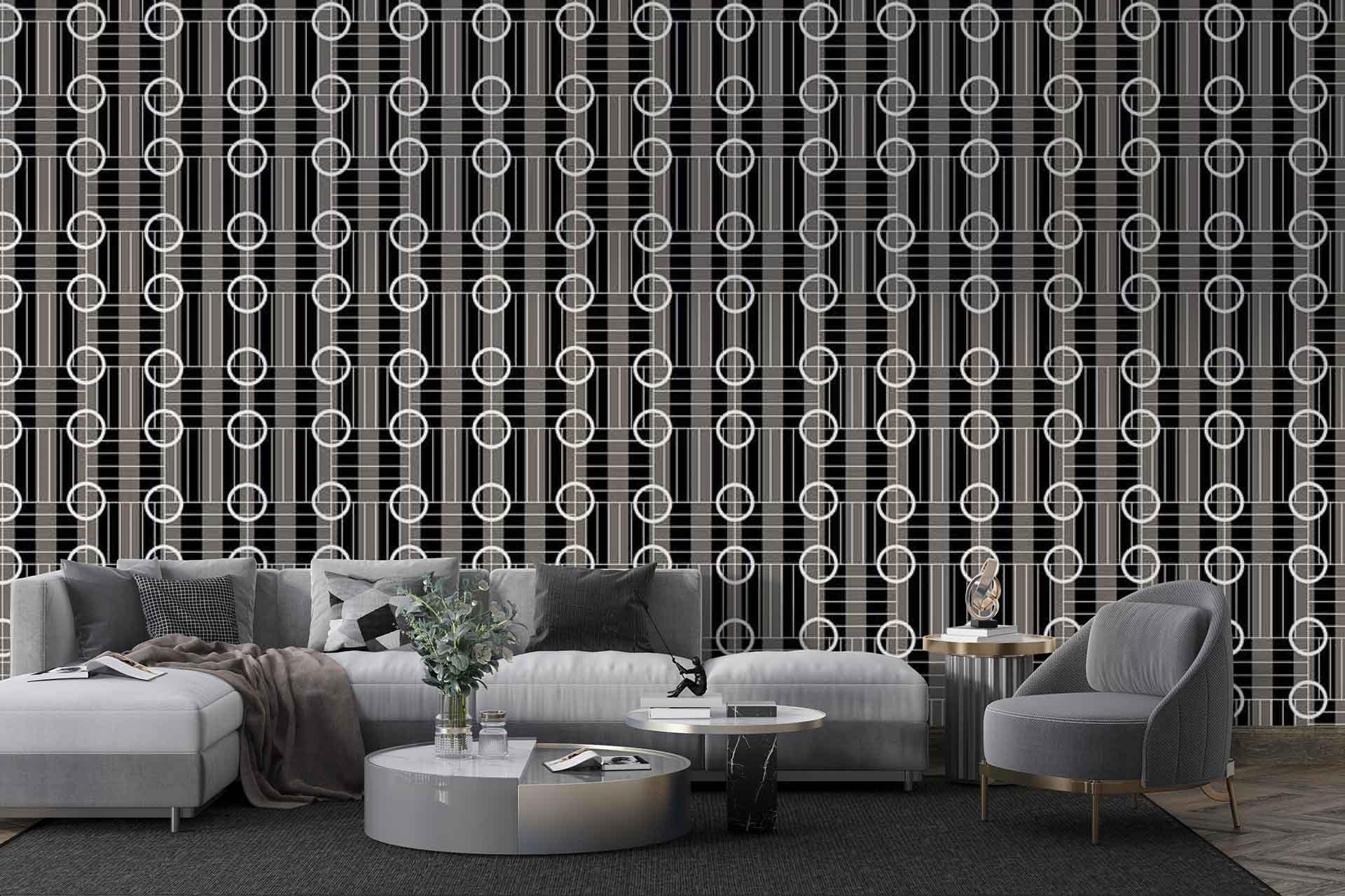 The wallpaper features a bold, geometric pattern with sharp lines and shapes in black and white. It consists of contrasting elements that create an eye-catching, modern design perfect for adding depth and interest to the living space. The monochrome palette of black and white makes it versatile while maintaining a striking aesthetic.
