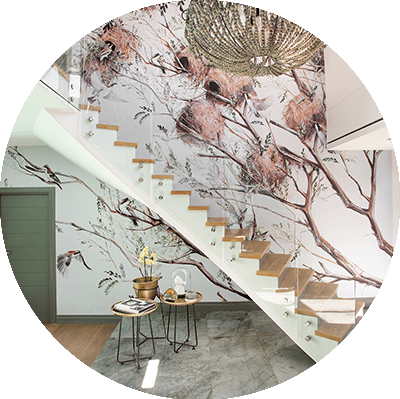 Nature-themed mural with birds and nests on tree branches, featuring a palette of greens, browns, and soft blues.