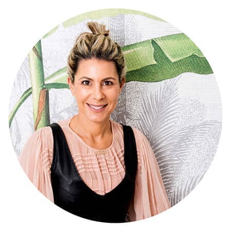 Decorative wallpaper featuring a leafy pattern with shades of green, dark blue, and hints of gold.