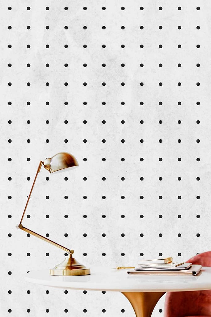 The wallpaper features a pattern of evenly spaced black dots on a white wall.