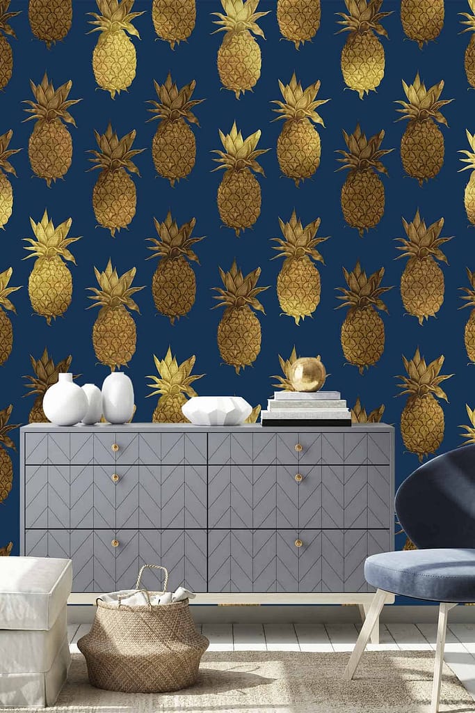 The modern living room's wallpaper is dark blue with a pattern of gold pineapples.