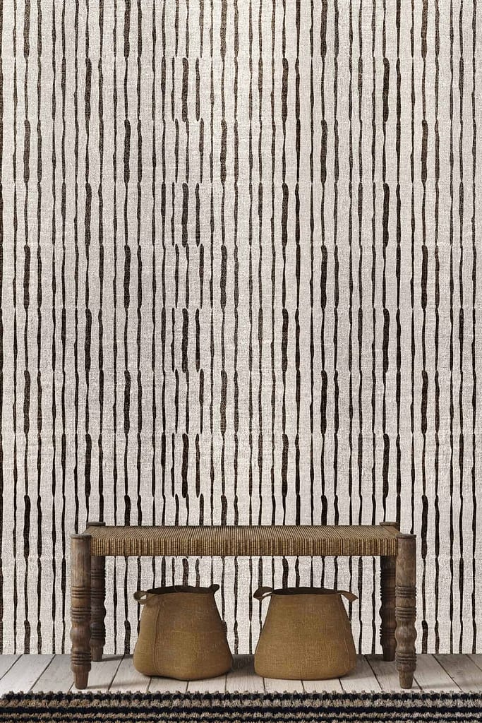 Vertical striped, textured wallpaper in beige and dark brown.