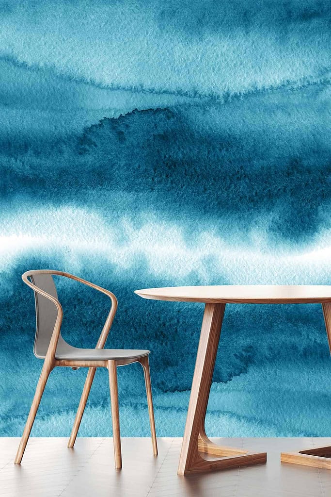 The wallpaper showcases a textured, abstract design featuring various hues of blue and white, reminiscent of Iceland's serene Blue Lagoon. Its watercolor style creates a tranquil and dynamic background with soft blending and subtle variations in color intensity.