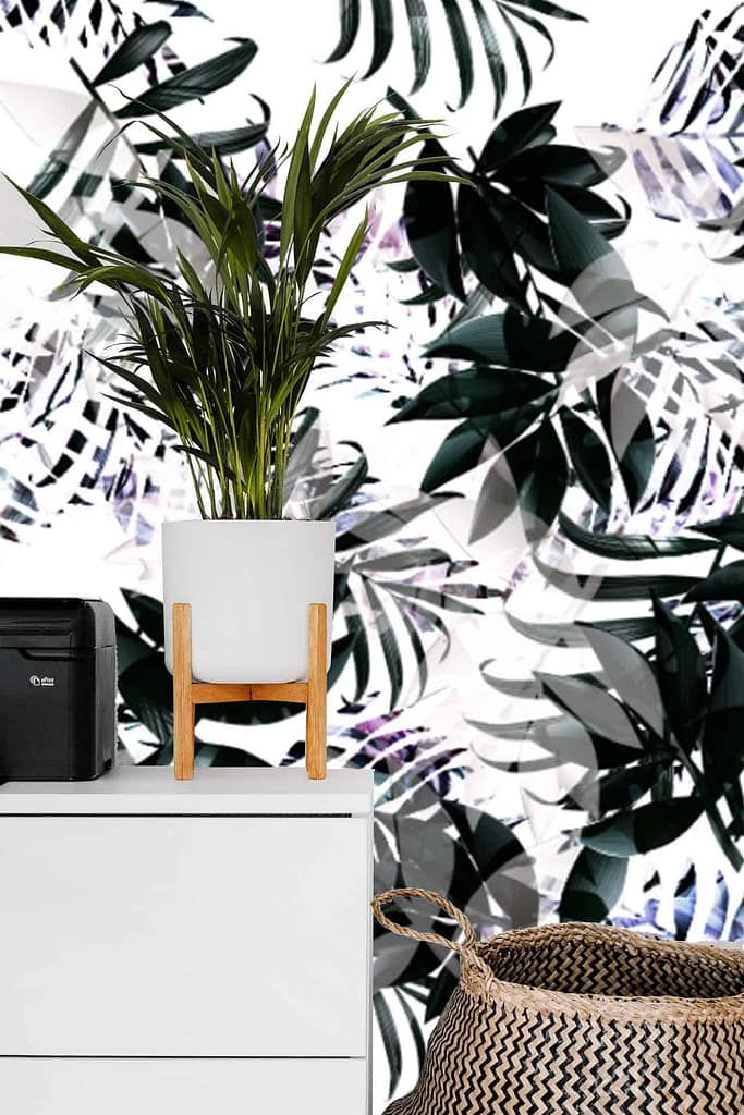 The wallpaper showcases vibrant tropical leaf patterns with shades of green, black, and white. It features intricate designs of various leaves creating a lush and dynamic background.