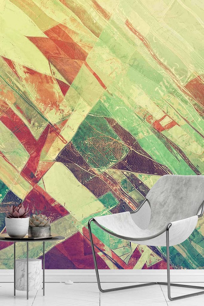 The wallpaper features a vibrant abstract mural with geometric patterns in shades of green, red, yellow, and purple, reminiscent of the vivid imagery in "Cutting for Stone.