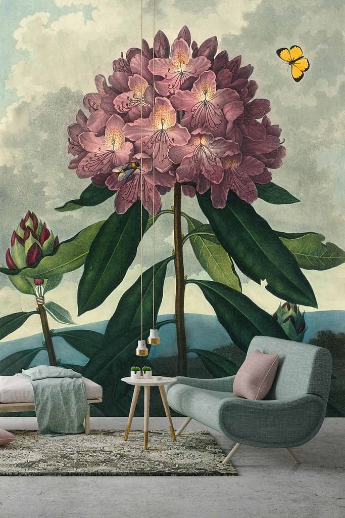 In the living room, a stunning large wall mural showcases a blooming pink flower with lush green leaves. This floral wallpaper, echoing the beauty of the Darling Buds of May, features delicate petals in various shades of pink and vibrant green foliage that stand out vividly against a subtle background. The radiant blooms create an eye-catching centerpiece and add an element of nature's tranquility to the space.
