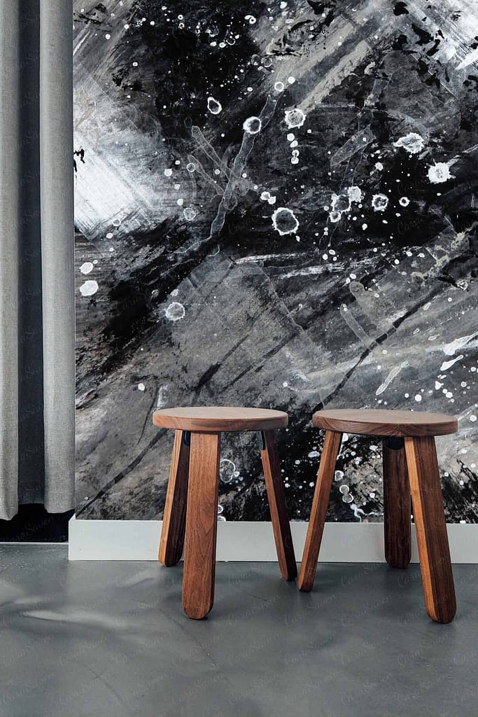 The wallpaper features an abstract design with black, white, and gray colors. It includes paint splatters and brush strokes, creating a dynamic and modern look.