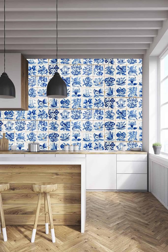 Dutch Blue patterned tiles wallpaper features various floral and marine designs. Predominantly blue and white, the wallpaper showcases intricate patterns of flowers, fish, and sea waves. This elegant design brings a touch of classic charm to modern kitchens.