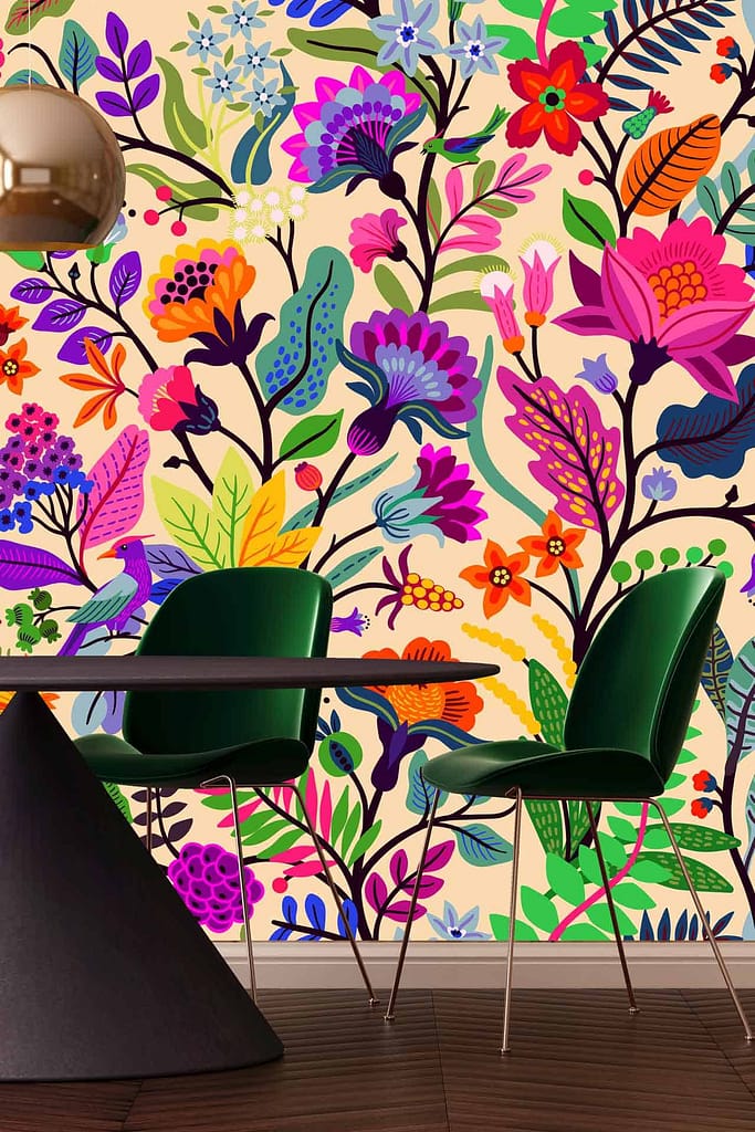 Floral wallpaper features vibrant and colorful flowers and leaves, inspired by Frida Kahlo. Elements include shades of pink, blue, purple, yellow flowers interspersed among green foliage. Bright and expressive design enhances the modern dining ambiance.