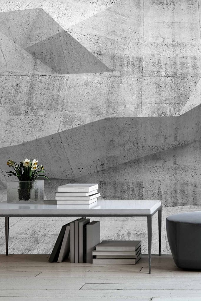 Textured, geometric concrete wall with various patterns and shades of gray.