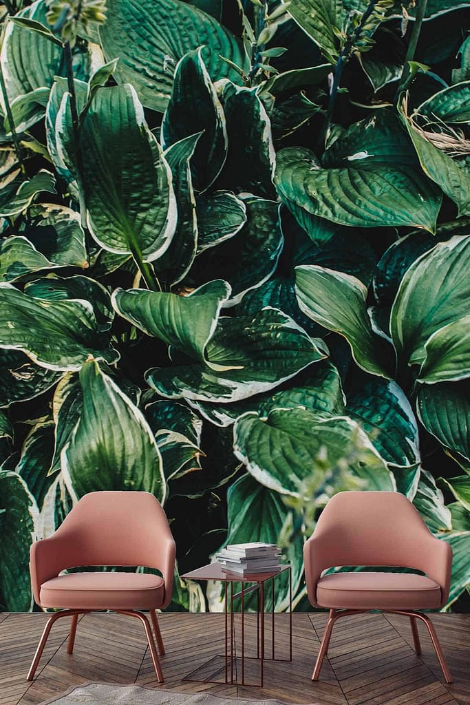 The wallpaper features a large, detailed green leaf pattern, creating a lush and vibrant atmosphere. The dominant colors are various shades of green.
