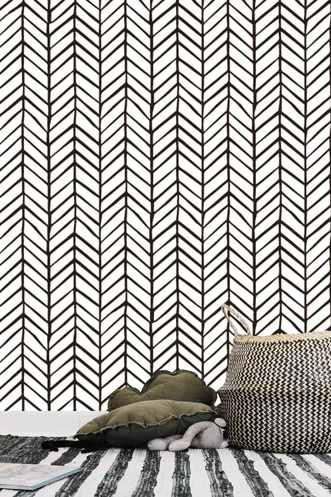 The room's wallpaper features a black and white herringbone pattern.