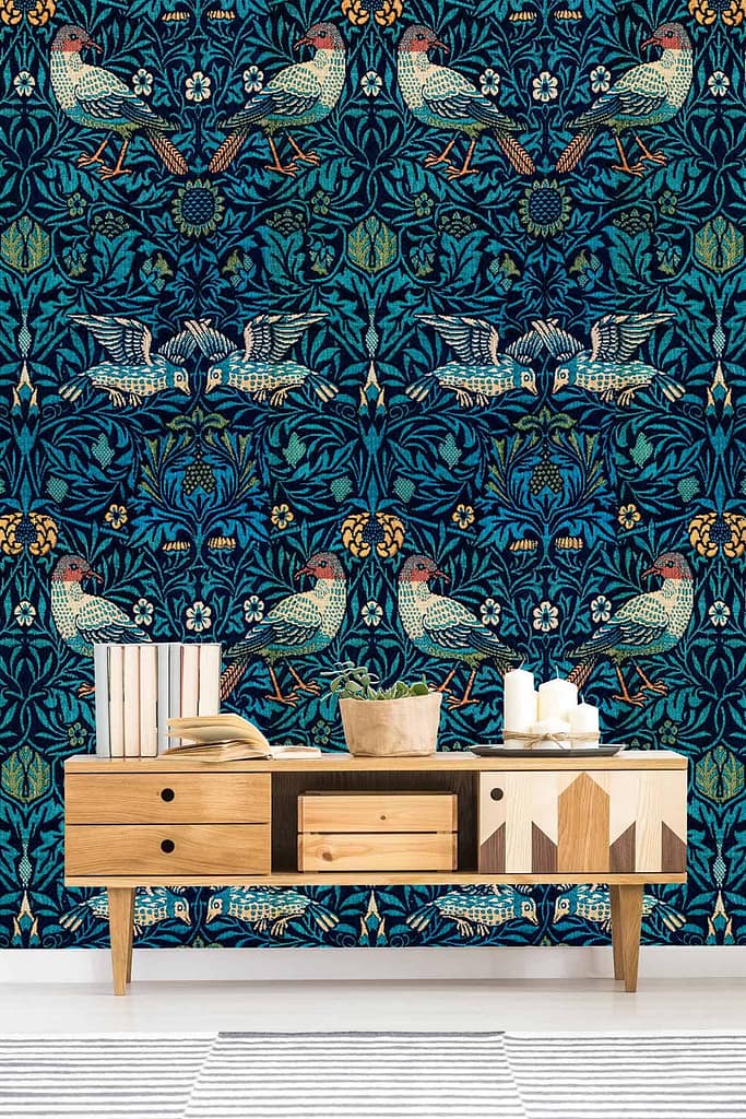 Dark teal wallpaper with symmetrical bird and floral designs, intricate patterns, historical charm, Leicester-inspired elements.