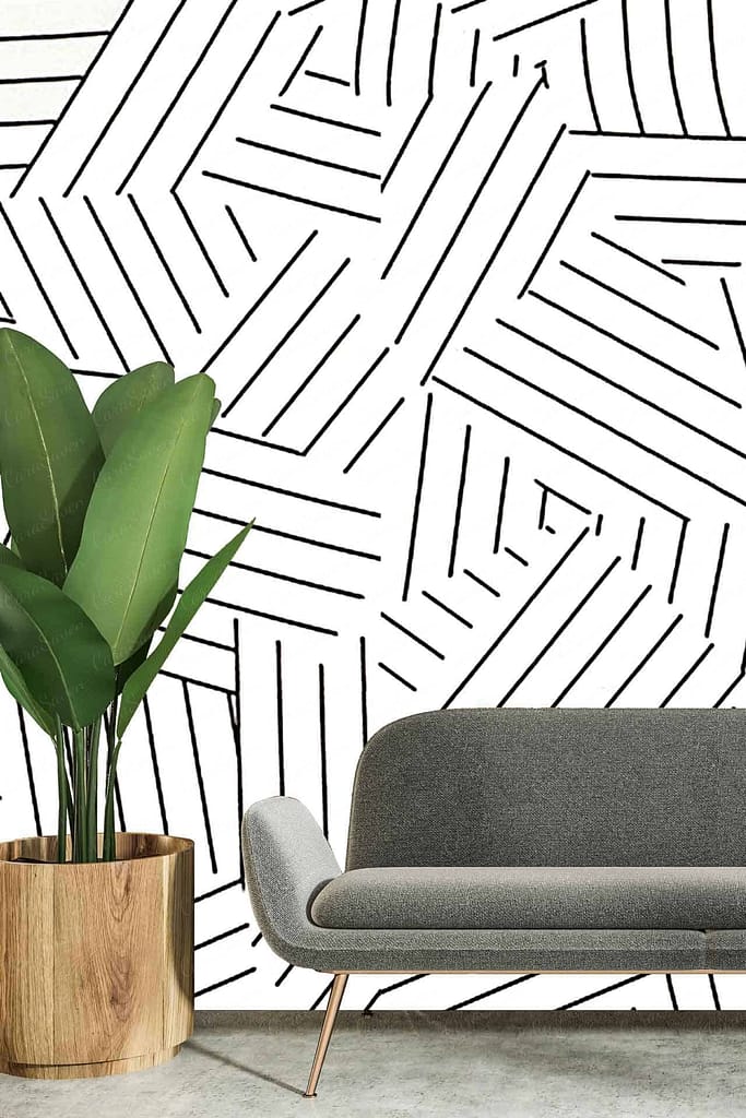 A modern living room features a white wall with a bold black geometric pattern composed of intersecting lines. Keywords: white wall, bold black geometric pattern, intersecting lines.