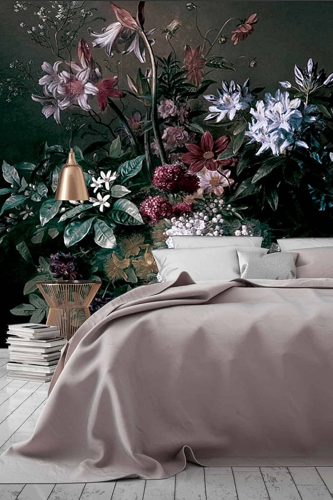 The wallpaper features a large floral mural with detailed, vibrant blooms in shades of pink, red, and orange, set against lush green foliage. Delicate vines weave through the flowers. The design is intricate, showcasing soft petal textures and realistic leaf patterns.